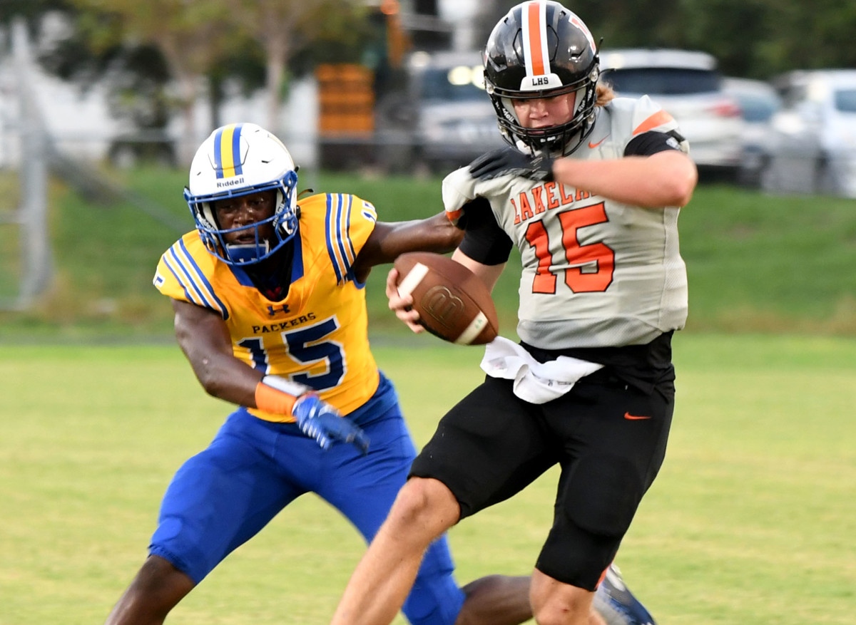 Lakeland quarterback Zander Smith is horse-collar tackled by Largo’s Isaiah Goodman on Friday at Largo.